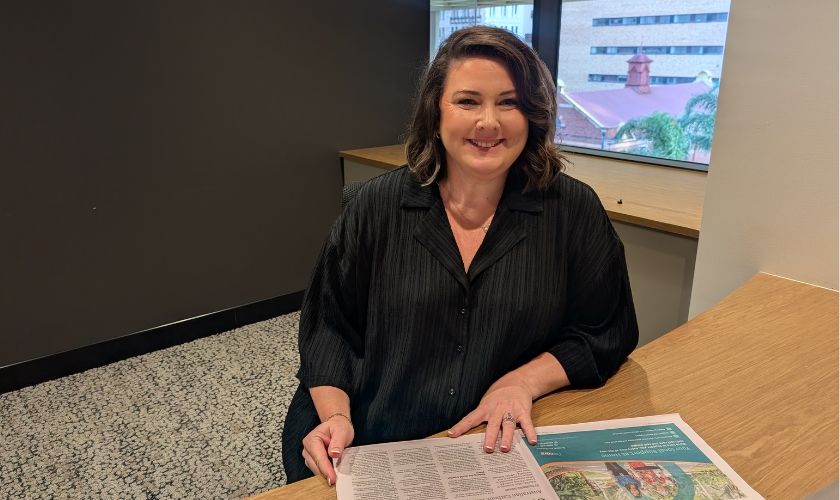 Shannon pictured at a desk, smiling