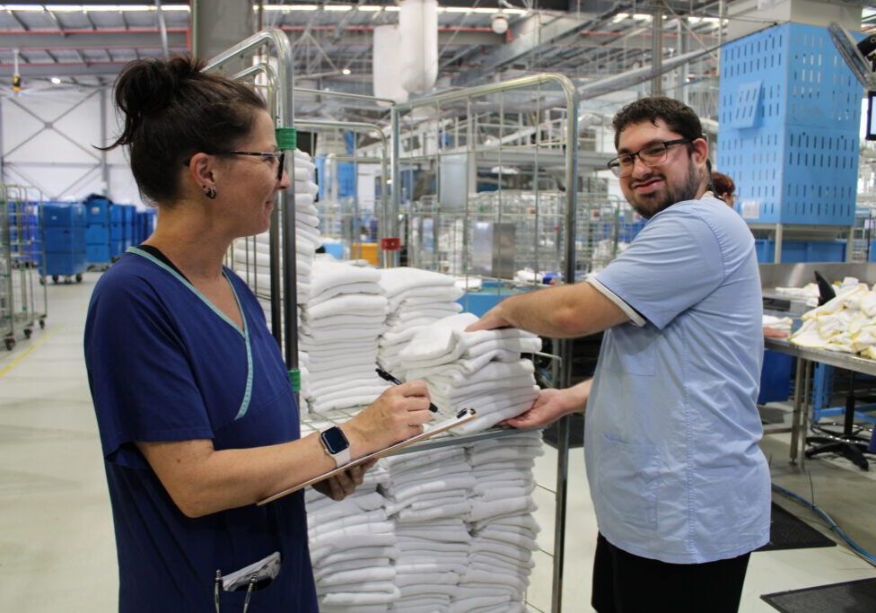 Two team members working together at Holy Cross Services