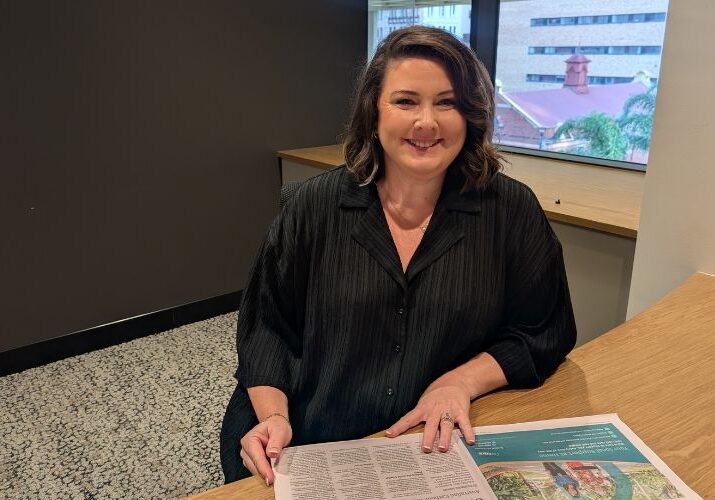 Shannon pictured at a desk, smiling